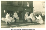 Men dressed in Ku Klux Klan robes in Mecca Day parade, The University of Iowa, 1916