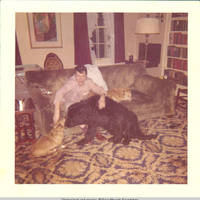 John, Sr. petting corgies and Sadie in living room