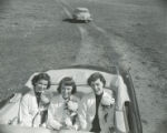 Homecoming queen and attendants riding in car, 1951
