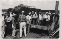 Group of Men Inspect a GEHL Forage Harvester.