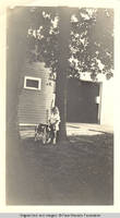 Vidie Burden and Jerry, the Dog standing in front of Barn