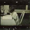 Small girl reading a book, The University of Iowa, January 12, 1938
