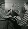 Two students determining the depth of a trench on a drainage model, 1957