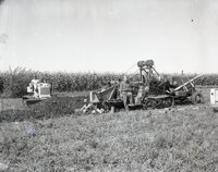 Ken Springsteen and two other men operate farm machinery in a field