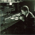 Man using a dropper for an experiment, The University of Iowa, 1930s