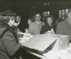 Individuals being served beverages at a Homecoming event, 1956
