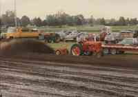 Red tractor and plow being driven at the Plymouth County Fair in July 1996.