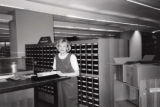 Olivia Madison looking through the card catalog, 2000