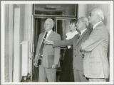 Earl O. Heady viewing a large chart of numbers on a wall in Hungary, 1979