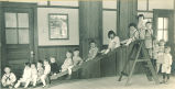 Children posing on an indoor slide, The University of Iowa, ca. 1920