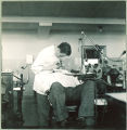 Dental student examining patient, The University of Iowa, 1940s