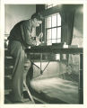 Engineering student manipulating a machine, The University of Iowa, 1939