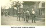 Men in assorted military uniforms, Homecoming parade, The University of Iowa, 1917