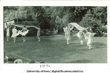 Women in costume dancing outside with large scarves, The University of Iowa, June 1924