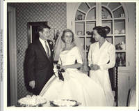 Frindy, John, Sr. and unknown woman standing in dining room