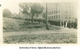 Commencement procession walking west on Washington St. past Engineering Building on right, The University of Iowa, June, 1913
