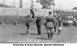 Governor John Hammill receiving American flag on Iowa Field, The University of Iowa, 1925