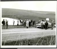 Crowd Observes by the Roadside