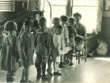 Line of small children in a playroom, The University of Iowa, 1920s