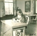 Girl playing at table, The University of Iowa, January 12, 1938