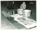 Cleaning light fixture in the Old Capitol, The University of Iowa, 1974