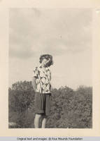 Girl by bushes