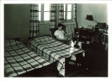 Student reading in a dorm room at Quadrangle Hall, The University of Iowa, 1948