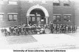Military band posing at south entrance of Old Armory, The University of Iowa, April 14, 1914