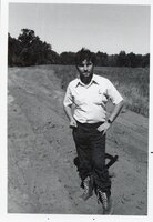 Men stand in dusty road
