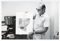 1975 Soil scientist Mel Brown man holds county oil survey map