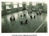Students in gymnasium posed in groups of four, The University of Iowa, 1930