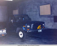 Truck parked inside barn with covered windows