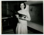 Betty Belle Gardner is holding a model transport plane to be placed in the wind tunnel in the Aeronautical Engineering Laboratory, 1943
