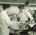 Dental students working with a patient, The University of Iowa, 1940s