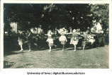 Women in costume running on the Pentacrest at a June celebration, The University of Iowa, 1920