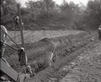 1970s Earthmoving machinery in field