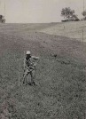 Unidentified people photographed in field and pasture