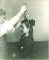 Measuring a child's head, The University of Iowa, ca. 1920