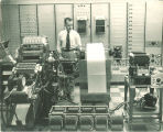 Man working with a room-sized computer, The University of Iowa, 1950s