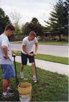1999 Students Marc Gorsch and Tylor Mann dig holes for the plantings of trees at West Burlington High School