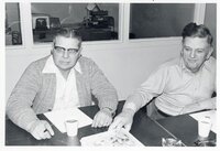 1970s Commissioners Joe Beckman and Dwight Stucker sit at a table during a meeting