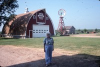 Community Conservation Award winner and chairperson, Mrs. Sokolowski standing in front of the Grand Meadow Heritage Center.
