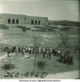 Crowds watch soldiers marching formations next to Kinnick Stadium, The University of Iowa, 1950s