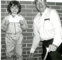 Unidentified child holding a certificate