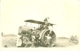 People surrounding threshing machine, Iowa, 1920s