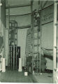 Men on scaffolding behind scenes on a stage, The University of Iowa, 1930s