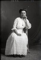 Woman with glasses, seated
