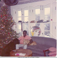 Ainsley Benard sitting on couch at Christmas with Victoria and Sadie