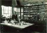 Dean R.A. Kuever in pharmacy laboratory, The University of Iowa, 1920s
