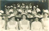 Nurses sitting at dinner tables, The University of Iowa, 1915